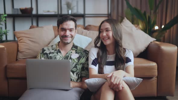 portrait of asian and caucasian marry couple sitting smile relax together