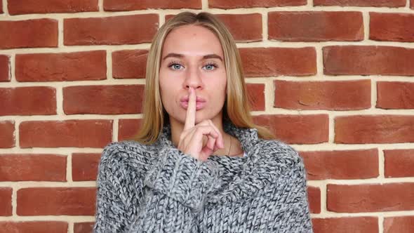 Gesture of Silence By Woman Finger on Lips alt