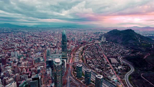 Dolly in aerial view of the business center of Santiago, Chile with cloudy sunset after rain in the alt