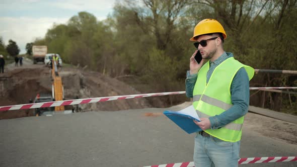 Portrait of Young Man Working Speaking By Phone alt