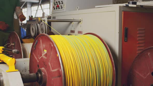 Spinning Reel with Yellow Cable in Cable Production Closeup