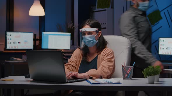 Workaholic Tired Businesswoman with Face Mask and Visor Against Covid19 alt