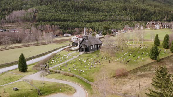 Flying Towards Heidal Church With Coniferous Forest Background In Selsverket, Norway. Aerial Drone alt
