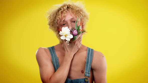 Handsome Androgynous Man Putting Hands on Neck Imitating Choking and Taking Off Flower Mask in Slow alt