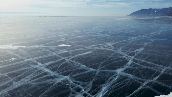 Aerial Perspective View of Beautiful Deep Blue Ice Textured Frozen Baikal Lake Surface From Above alt