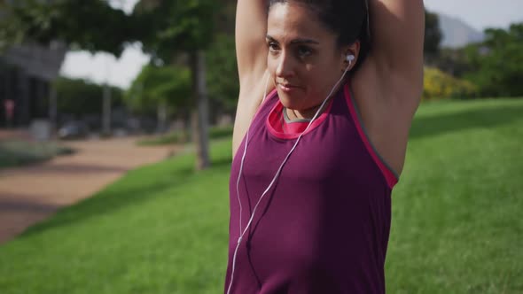 Caucasian woman stretching in a park alt