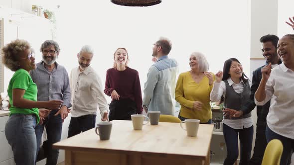 Happy multiracial people with different ages and ethnicities having fun dancing