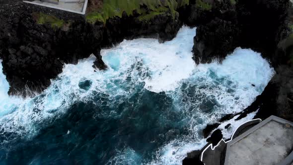 Top down View of Huge Waves Crashing Into the Coastline of Porto Moniz Madeira island, Portugal