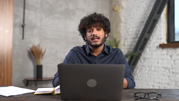 Cheerful Attractive Indian Guy Using Laptop for Video Communication