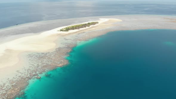 Aerial: Flying over idyllic atoll, travel destination Wakatobi National Park Ind alt
