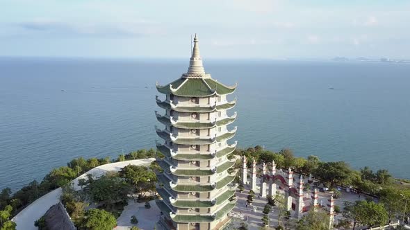 Aerial View Buddhist Temple Pagoda with Gate on Coastal Edge alt