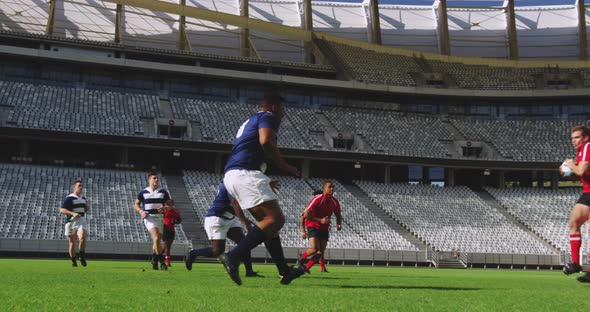 Rugby Players Playing Rugby Match in Stadium alt