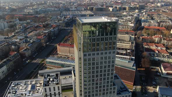 Drone flying around a new skyscraper in Krakow city, Poland alt