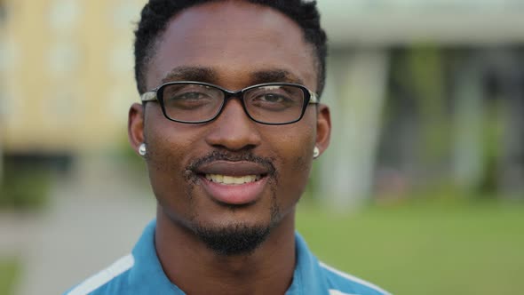 Portrait of Young African American Man with Beard in Glasses Looking at Camera alt