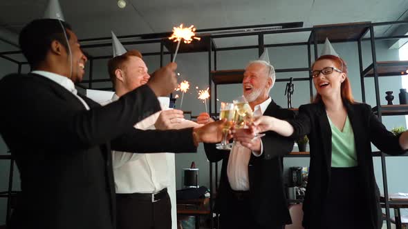 Business Team of Multiethnic Coworkers People Holding Bengal Lights, Clinking Glasses of Champagne.