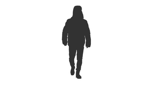 Silhouette of Adult Man Walking in Winter Clothes