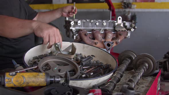 Assembling Parts Of Overhauled Car Engine In The Repair Shop 1 alt