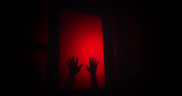 Creepy hands slap against the glass door