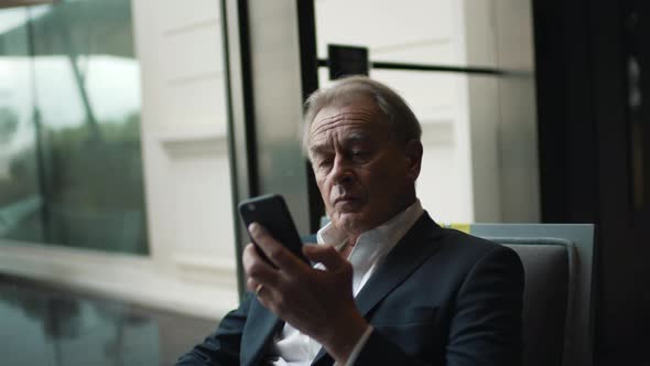 Old Businessman Talking on Cell Phone