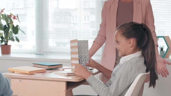 Female Teacher Confiscating Students Phone in Class alt