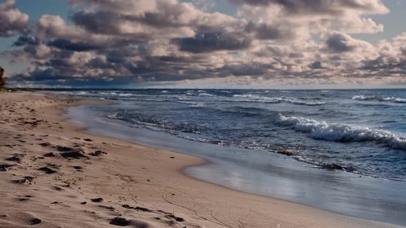Deserted sandy seashore in stormy weather. 