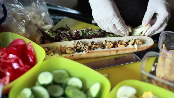 Cook Makes a Sandwich with a Seafood on Festival Street Food alt