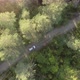 Aerial View of the White Car on Road in the Forest - VideoHive Item for Sale