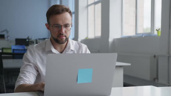 Close Up View of a Man in Glasses at the Computer alt