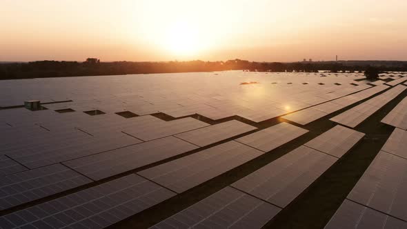 Aerial View Over Solar Farm at Sunrise