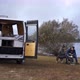 Caucasian couple eating breakfast on a lake with a camper van living van life social distancing - VideoHive Item for Sale