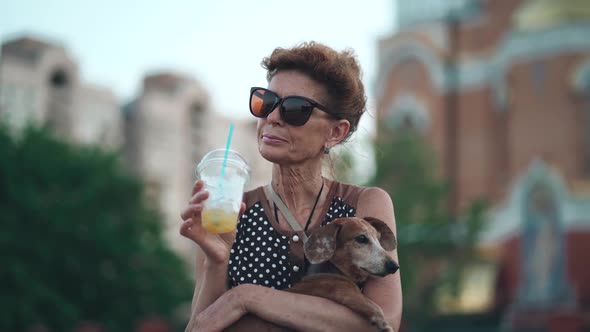 Summer Vacation of Lonely Elderly Woman and Her Dog Friend Among Passing Crowd People on Boardwalk alt