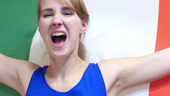Italian Young Woman Celebrating while Holding Flag of Italy alt