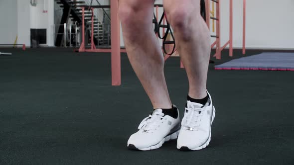 Man is Warming Before His Workout Skipping the Rope in Gym Legs Closeup