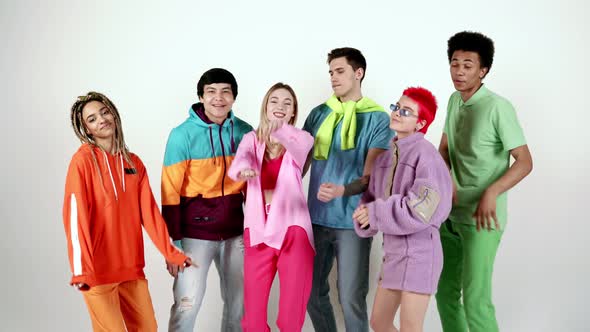 Group of teenagers in colorful clothes dancing together