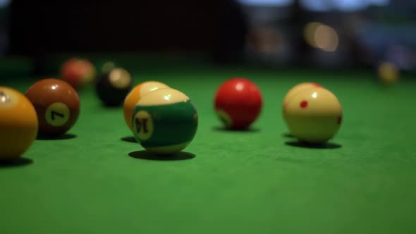Kicking of Balls with Pool Stick on Table with Green Fabric alt