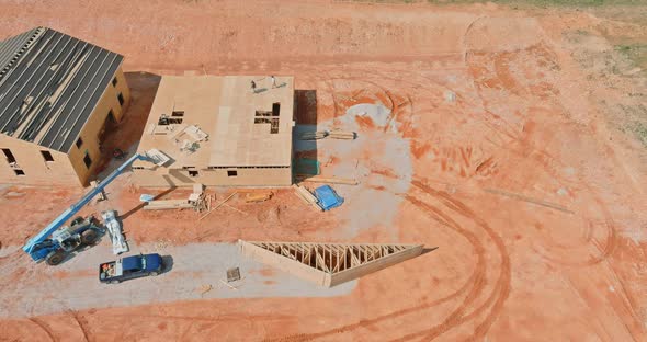 Wood frame of residential home View of a large under construction site alt