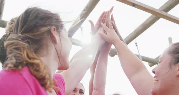 Female friends enjoying exercising at boot camp together alt