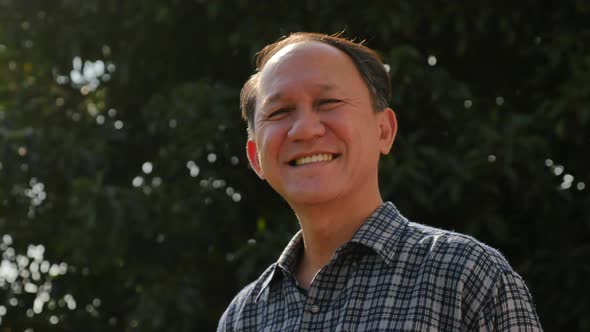 Close Up Of Happy Asian Old Man With Nature Background alt
