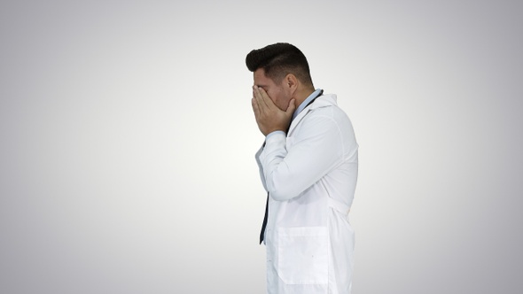 Tired doctor passing by on gradient background. alt