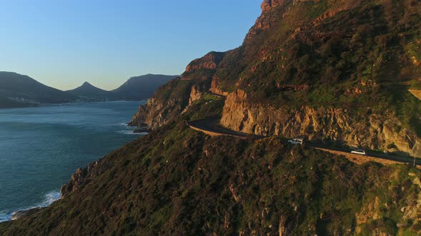 Aerial Shot of Cars Travelling Along a Coastal Mountain Pass