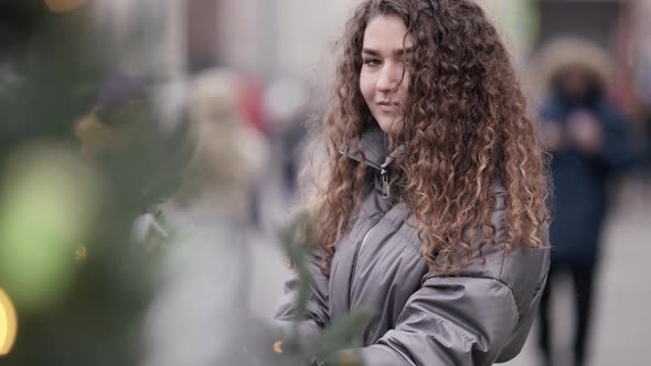 Magic Christmas Mood Pretty Young Woman on Street in City Viewing Decorated Tree alt