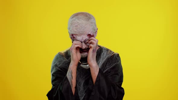 Upset Halloween Zombie Man Wipes Tears and Cries From Despair Being Sad Because of Unfair Things alt