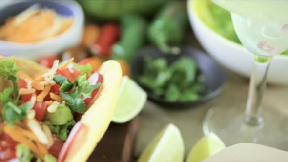 Ground beef tacos with romaine lettuce, diced tomatoes, radishes, and shredded cheddar cheese. alt