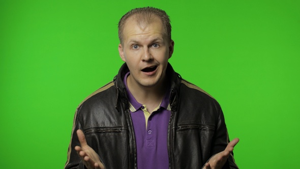 Annoyed Rocker Man Raising Hands in Anger and Shouting What, Why, How, Quarreling for Troubles alt