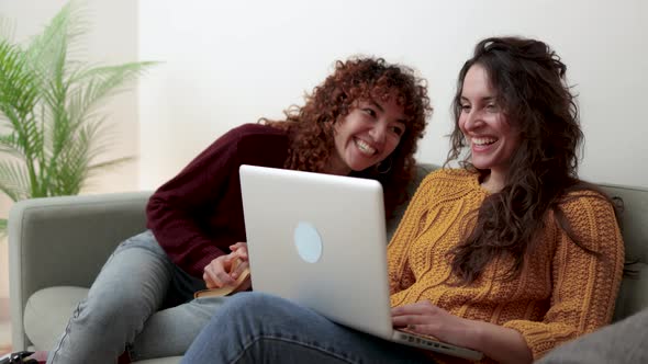 Happy Gay Couple of Women Having Fun Using Computer Laptop at Home LGBT Lesbian Relationship Concept alt