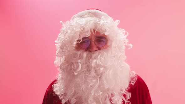 Santa Claus Portrait Standing on Red Background alt