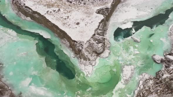 Stunning Aerial View of Vivid Turquoise River Chuya Partly Frozen in Winter