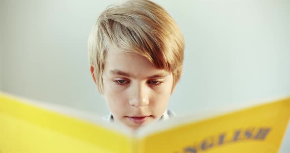 Boy Reading English Book Closeup