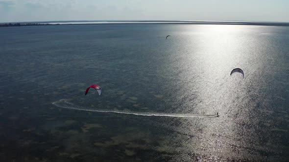 People go kitesurfing on the sea.
