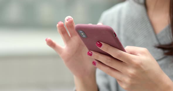 Woman use of smart phone in city alt